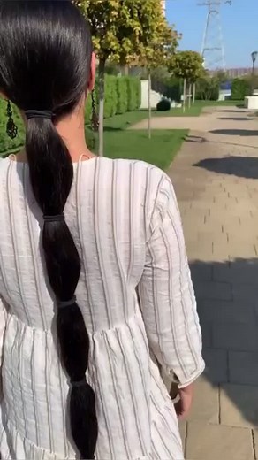 Woman Strolling Through a Beautiful Garden