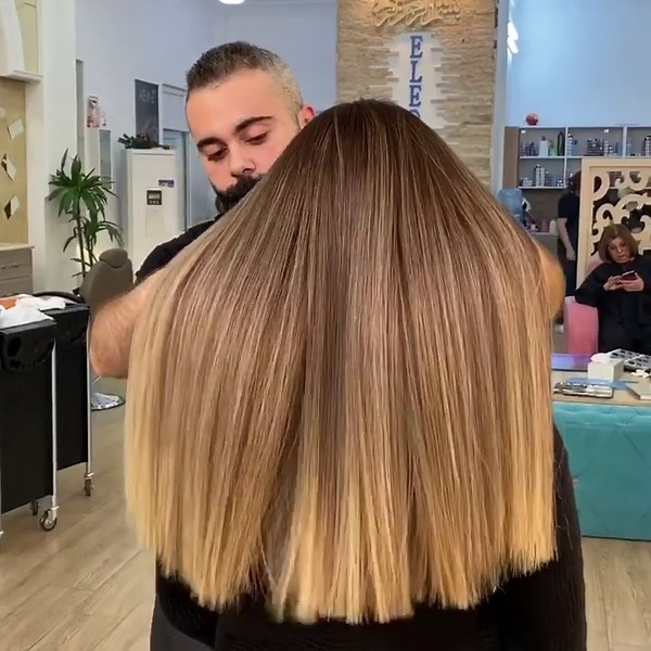 Creating butterscotch blonde glass hair with blunt styling resulting in silky golden dimension