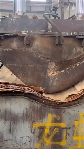 A hydraulic machine that is being used to press the material neatly