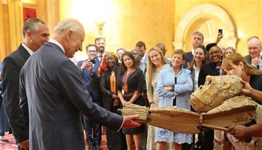 King Charles shakes hands with life-size gorilla puppet at Lancaster House