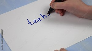Young girl writes on a sheet of paper various words and expressions of gen z slang. Word "teehee", its definition and meaning Stock Video