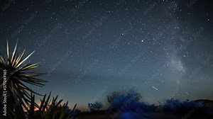 This astro time lapse video shows an epic milky way galactic center moving through the dark night sky time over a remote desert landscape.