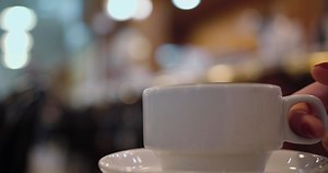 Woman having a coffee at a bar