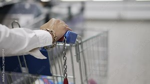 woman pushing shopping cart in shopping mall, slow motion