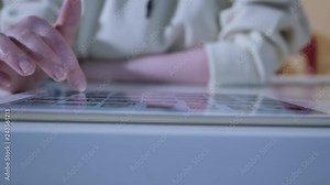 Woman using interactive touchscreen display at urban exhibition - scrolling and touching. Entertainment and technology concept