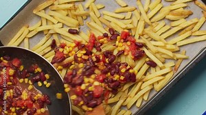 Flat lay cooking: making mexican food on the hot pan with beans, corn and fries, 4k