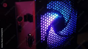 Neon colorful pc processor cooler rotating close-up. Neon system unit, computer case atx, modern personal gaming computer with neon light.