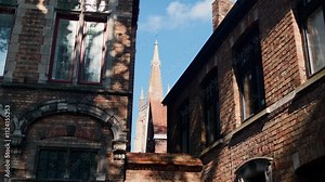 Bruges Church of Our Lady towers between historic brick buildings