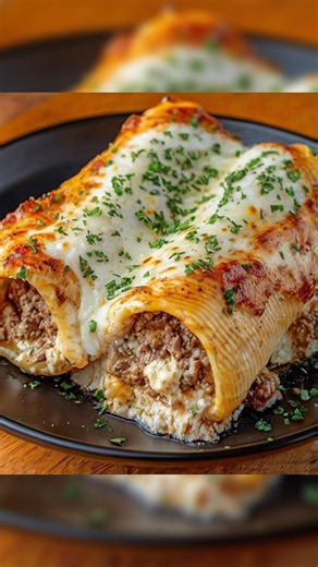 Beef and Cheese Stuffed Manicotti YAY OR NAY!🤤🔥 . Ingredients: 12 manicotti shells 1 lb ground beef 1 small onion, diced 2 cloves garlic, minced 2 cups ricotta cheese 1 1/2 cups shredded mozzarella cheese 1/2 cup grated Parmesan cheese 1 egg 1 tsp Italian seasoning 1/2 tsp salt 1/2 tsp black pepper 3 cups marinara sauce 2 tbsp olive oil Instructions: Cook the Pasta: Bring a large pot of salted water to a boil. Cook manicotti shells until just al dente, about 7–8 minutes. Drain and set aside to