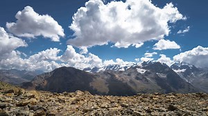 Wild high mountain landscape with moving clouds