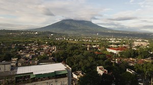 Premium stock video - Rooftop restaurant with stunning view of cloud-capped mount salak in west java, indonesia