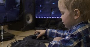 Little Child Learning How to Use Computer Mouse Surfing Internet Playing Watching PC. Boy Sits in Front of Green Screen Monitors. Father's Editing PC Workstation. Gaming PC. 10 bit HLG