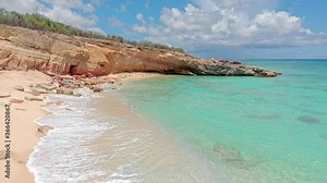 Sea water splashing into white sandy beaches on the Caribbean islands. Cupecoy beach St.maarten