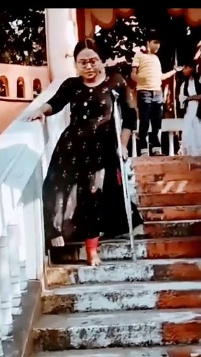Polio short leg woman walking down stairs.
