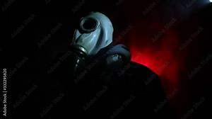 Environmental disaster. Post-apocalyptic survivor in gas mask on a dark background. Dramatic portrait of a man wearing a gas mask. Means for radiation protection. Selective focus
