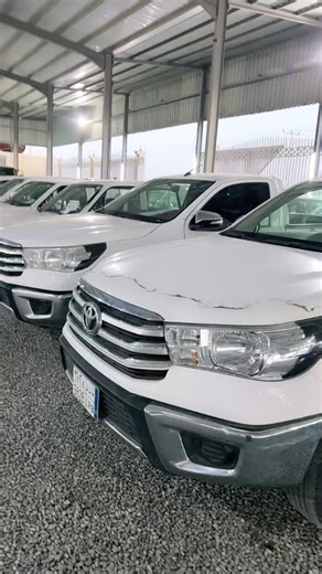 Damaged White Toyota Pickup Trucks in Storage Area
