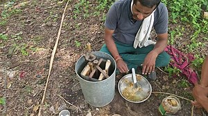 A Indian beekeeper extracting honey with a honey extractor. Beekeeping. Honey production