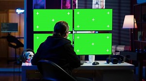 Cybercriminal coding on green screen monitors, developing zero day exploit undetectable by antivirus software. Hacker using mockup PC displays to build script tricking firewalls, camera A