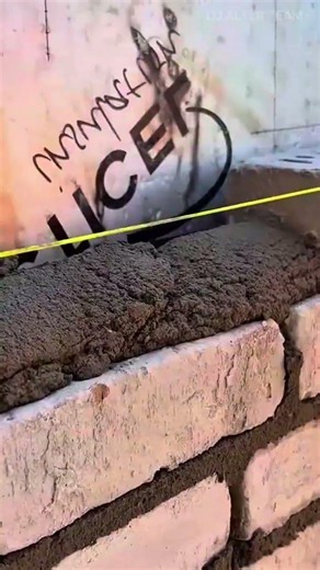 laying white bricks with mortar to build a sturdy wall structure and ensuring alignment for precisio
