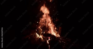 Bonefire, fire flames close-up in campfire. Burning red hot sparks rise from small fire in the night. Stock Video
