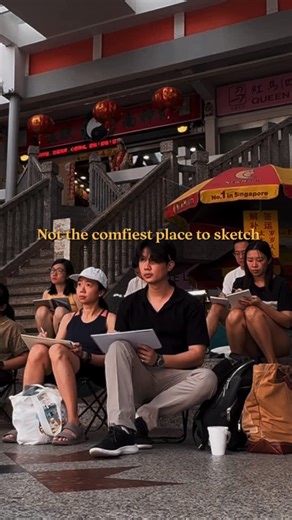 Chen Xi 陈熙 on Instagram: "We planted ourselves right in the middle of the bustling street — sweating, looking for a space to settle, finding calm together in the noisy and humid environment. The best part? After a while, people stopping by to see, chat, and just be with us. I’ve said it before and I’ll say it again - there is something beautiful about art being a shared language, even with strangers ❤️✨ #artcommunity #urbansketching #drawingoutside #creativeflow #artlife #art #artist #urbansketc