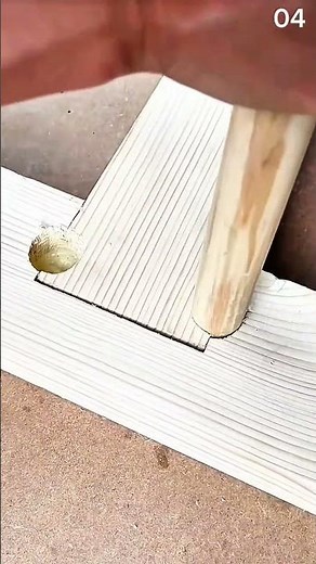 Wooden pole slides into grooved plank—joinery clicks with crafted precision