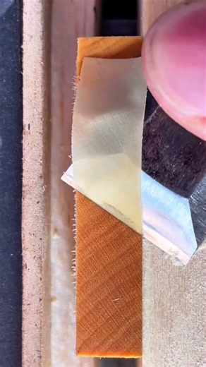 shaving a thin layer of wood with a sharp chisel to create a smooth surface for woodworking projects