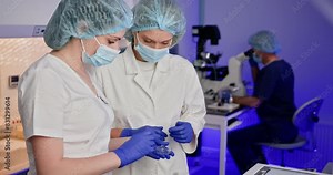 Embryologists in a laboratory setting performing artificial fertilization of human eggs, showcasing the intricate process of IVF and reproductive science. Embryologists Laboratory Setting