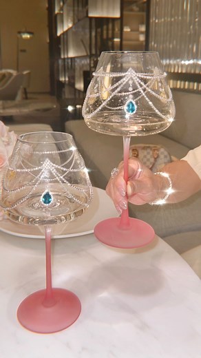 New Design: Aurora Diamonds Wine Glass Cup Set✨💕. A glass kissed by light and born of dreams.Experience elegance in its most luminous form. Each glass is hand-blown and individually adorned with radiant diamonds and pearls, draped in cascading crystal chains that flow beautifully as you sip. Made from premium, high-quality glass with a sleek, ultra-thin stem and XXL bowl, these exclusive wine glasses capture light and romance in every detail. Perfect for intimate dinners, special occasions, or 