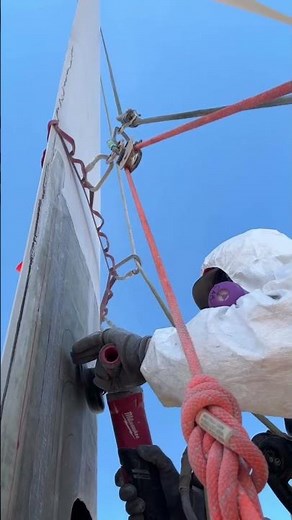 Wind Turbine Technician Repairs Turbine Blades