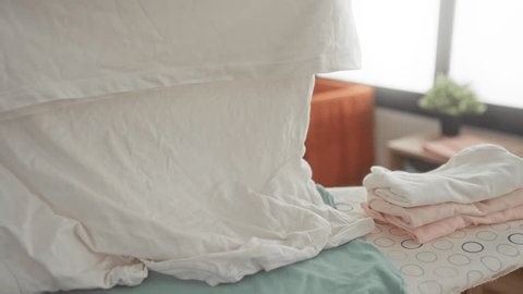 clip-3966657957-woman-holds-stained-shirt-building-laundry-room