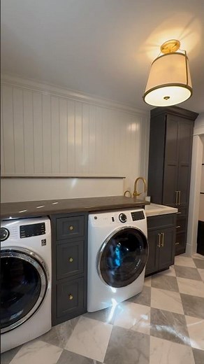 Finally upgraded our laundry room with a folding table, a paneled accent wall, and built-in cabinets