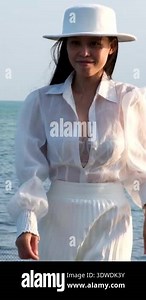 Set of videos Vietnamese woman in white dress and hat walking on wooden pier climbing ladder and looking at sea on Vietnam island.