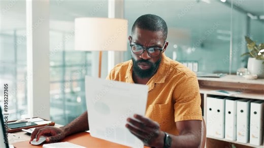 Black man, computer and documents with review at office for typing, confused or glasses at media company. Person, pc and admin with stress, check and search for project management at creative agency