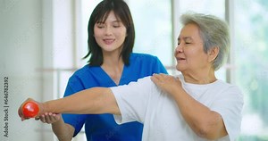 Beautiful asian nurse taking care of senior woman to exercise at hospital. She feeling happy when take care senior woman. Healthcare, Retirement, Volunteer, Caregiver and Lifestyle concept.