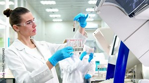 Doctor holding Blood sample tube for analysis in Hematology laboratory. Technician lab with Blood testing over requisition report for Hematology test