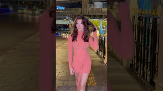 Model rocks hot pink dress on fun night out in Bangkok
