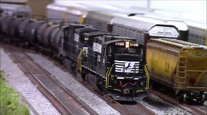 Rob Zeno sent us this short clip of our Rivet Counter HO Scale Norfolk Southern C39-8s pulling a tank train on his layout. Near the end of the video are two Rivet Counter DASH-9 locomotives which belong to Troy Combs, a fellow NS modeler. Rob remarked: “This was my first close look at the DASH-9 model and all I can say is, ‘Wow, these things are amazing!’ I cannot wait for the Top Hat DASH-9s to arrive!” Order the Rivet Counter HO C39-8: http://bit.ly/RivetCounterHOScaleC39-8 Order the Rivet Cou