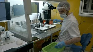 Medical doctor using the modern ivf equipment at the pregnancy clinic. Doctor puts the ivf human embryos into liquid nitrogen at a clinic. Clinic doctor operating the ivf impregnation machine.