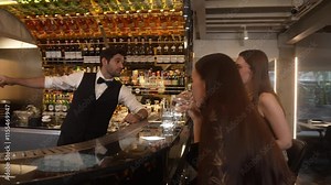 Serving special drink gin fizz of mixed cocktail to smiling VIP customer with couple or friend group by smart bartender service at beverage counter bar luxury nightlife at nightclub party. Vinosity.