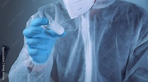Scientist holding ampule with white powder, illegal pharmacy production, drugs. Laboratory assistant examines glass medical ampoule for injection. Penicillin dry powder medicine. Antibiotic injection