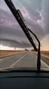 Massive Tornado Filmed in Kansas Dodge City, Kansas — May 24, 2024 Storm chasers in western Kansas captured breathtaking footage of a large, powerful tornado developing beneath a monstrous supercell thunderstorm. The video, filmed from a car driving toward the storm, shows the dramatic moment the vortex forms and touches down on the rural plains. The footage reveals an enormous, dark shelf cloud stretching across the horizon. As the vehicle advances, a prominent funnel cloud descends on the left