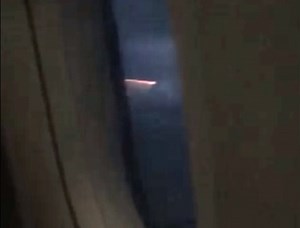 Air-borne traveller captures cigarette shaped fire in the night sky