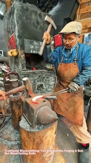Traditional Blacksmithing: Two Blacksmiths Forging A Red-Hot Wood-Cutting Knife