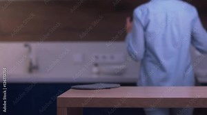 Young attractive housewife putting on an apron on a modern home kitchen, preparing to cook. 4K UHD RAW edited footage