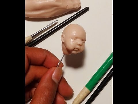 Sculpting ooak polymer clay baby Jack face