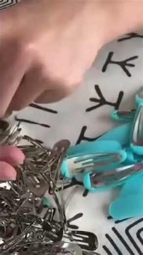 a person is stringing hair clips