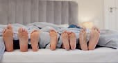 Sleeping, feet and family wake up in a bed with morning energy,...