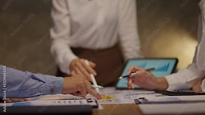 Business people pointing to graph and chart to analyze market, sale, balance sheet, account, net profit data to see the growth of the organization and to develop product.