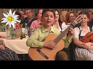Young boy sings traditional folk Jodler